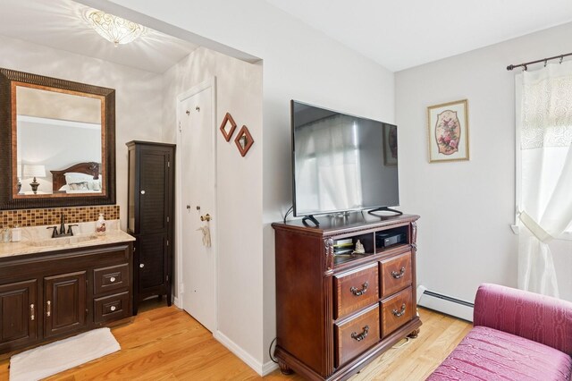 22 Ridge Rd, Shirley, NY 11967 - living room with baseboard heating and light wood-style flooring