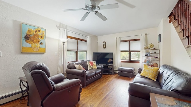 3 Byram Ridge Rd S, Armonk, NY 10504 - living area featuring baseboard heating, wood finished floors, a ceiling fan, stairway, and a textured wall
