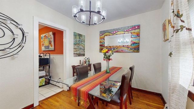 3 Byram Ridge Rd S, Armonk, NY 10504 - dining room with a chandelier, baseboard heating, and wood finished floors