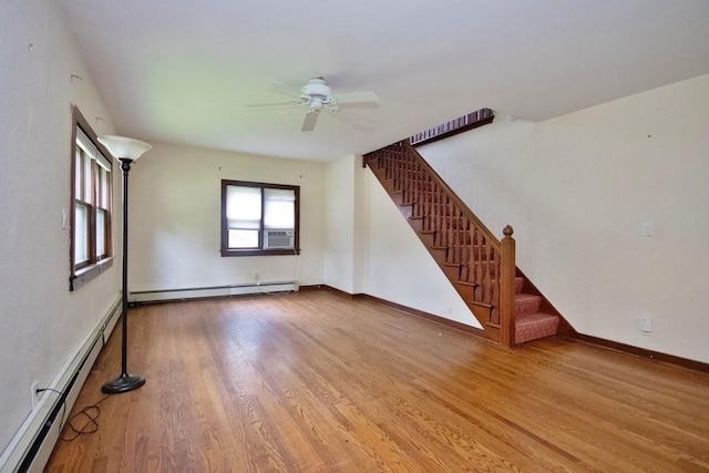 3 Byram Ridge Rd S, Armonk, NY 10504 - unfurnished living room featuring a baseboard heating unit, baseboard heating, wood finished floors, stairway, and a ceiling fan