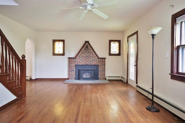 3 Byram Ridge Rd S, Armonk, NY 10504 - unfurnished living room with a baseboard heating unit, wood finished floors, and healthy amount of natural light