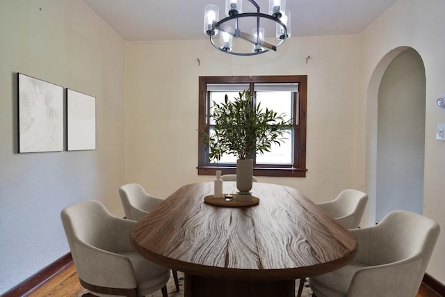 3 Byram Ridge Rd S, Armonk, NY 10504 - dining area featuring a chandelier, arched walkways, and wood finished floors
