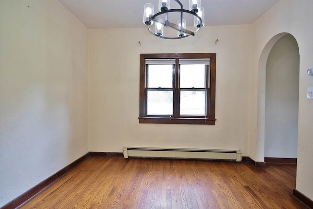 3 Byram Ridge Rd S, Armonk, NY 10504 - spare room with a chandelier, arched walkways, wood finished floors, and a baseboard radiator
