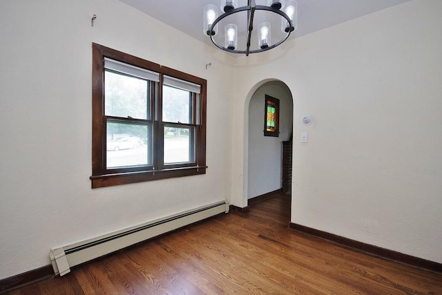 3 Byram Ridge Rd S, Armonk, NY 10504 - empty room featuring baseboard heating, arched walkways, a chandelier, and wood finished floors