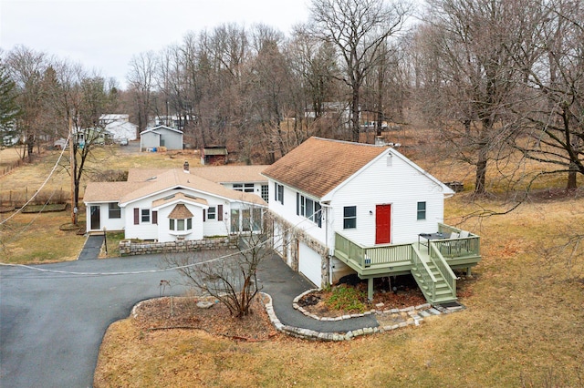 11-13 Eldridge Ln, Red Hook, NY 12571 - view of front of house with asphalt driveway, a wooden deck, stairs, an attached garage, and a front lawn