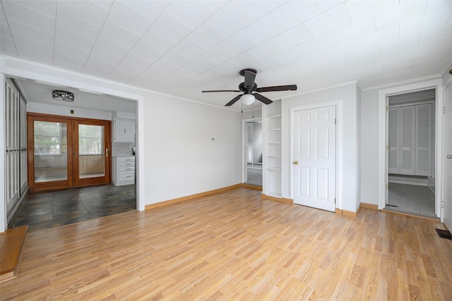 11-13 Eldridge Ln, Red Hook, NY 12571 - unfurnished living room featuring ornamental molding, baseboards, wood finished floors, french doors, and a ceiling fan