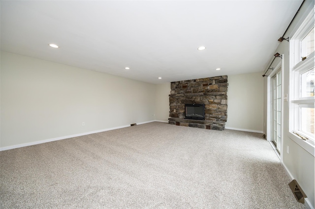 11-13 Eldridge Ln, Red Hook, NY 12571 - unfurnished living room with carpet, a stone fireplace, recessed lighting, and baseboards