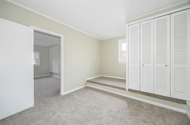 11-13 Eldridge Ln, Red Hook, NY 12571 - unfurnished bedroom with crown molding, carpet floors, baseboards, and a closet