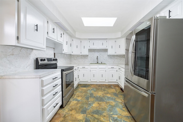 11-13 Eldridge Ln, Red Hook, NY 12571 - kitchen featuring stainless steel appliances, a sink, stone finish flooring, a skylight, and light countertops