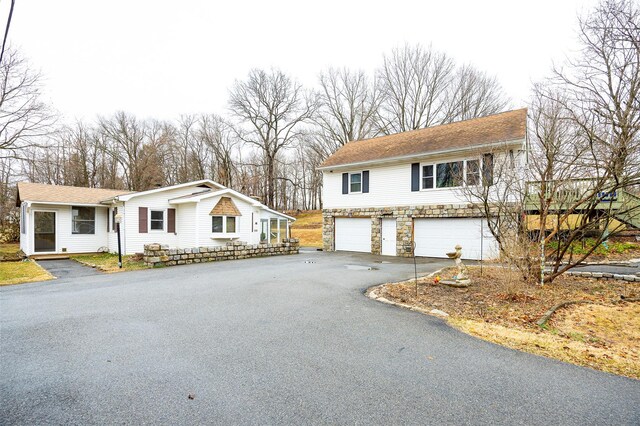 11-13 Eldridge Ln, Red Hook, NY 12571 - view of front of property featuring driveway, an attached garage, stone siding, and a shingled roof