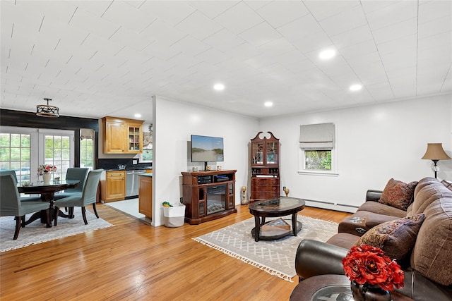 658 Northville Tpke, Riverhead, NY 11901 - living room featuring healthy amount of natural light, a baseboard radiator, light wood finished floors, and recessed lighting