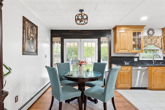 658 Northville Tpke, Riverhead, NY 11901 - dining space featuring baseboard heating and light wood-type flooring
