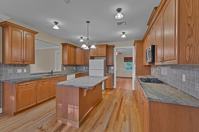 9 Joseph Bow Ct, Pearl River, NY 10965 - kitchen featuring appliances with stainless steel finishes, tasteful backsplash, a center island, and light wood-type flooring