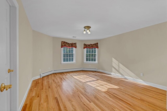 9 Joseph Bow Ct, Pearl River, NY 10965 - unfurnished room featuring light wood finished floors, a baseboard heating unit, and a chandelier