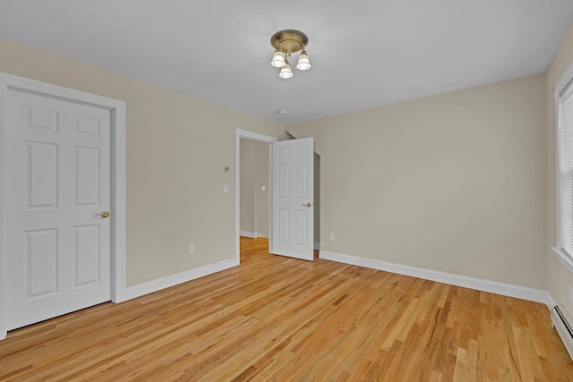 9 Joseph Bow Ct, Pearl River, NY 10965 - unfurnished bedroom with light wood-type flooring and a baseboard heating unit