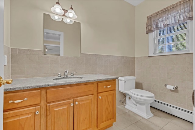 9 Joseph Bow Ct, Pearl River, NY 10965 - bathroom featuring baseboard heating, tile patterned flooring, tile walls, vanity, and wainscoting
