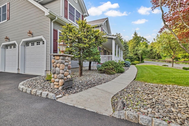 9 Joseph Bow Ct, Pearl River, NY 10965 - view of side of home featuring a garage, asphalt driveway, and a yard