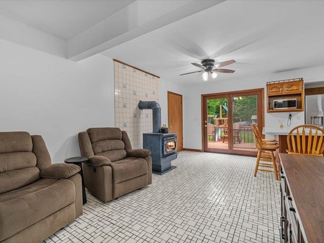 708 Kirbytown Rd, Middletown, NY 10940 - living room with a wood stove, ceiling fan, and baseboards