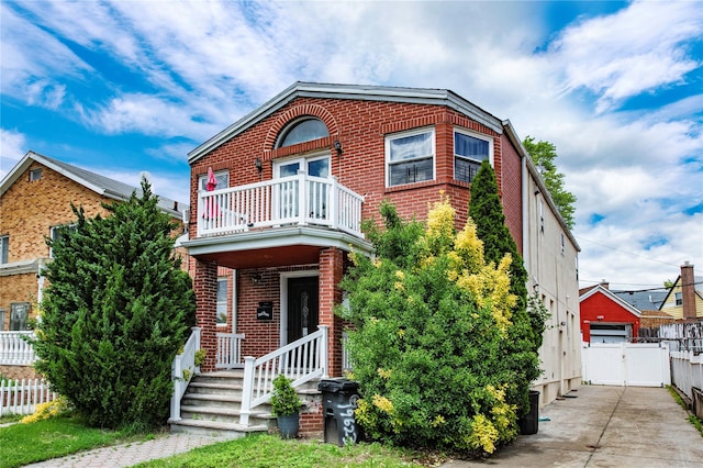 19623 56th Ave, Fresh Meadows, NY 11365 - view of front of house featuring a balcony and brick siding