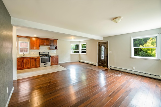19623 56th Ave, Fresh Meadows, NY 11365 - unfurnished living room featuring baseboard heating, a baseboard radiator, and wood finished floors
