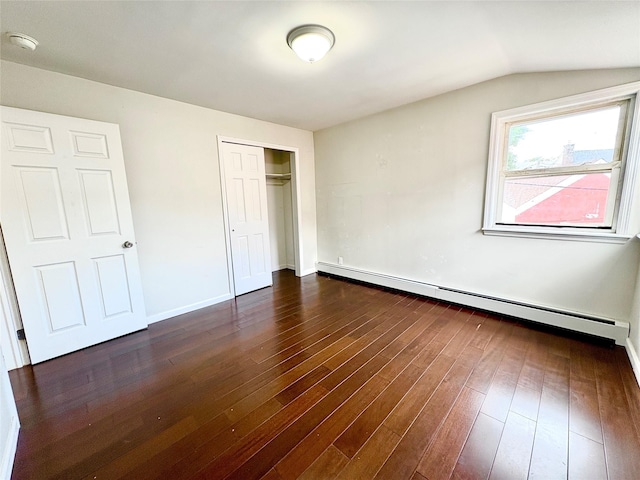 19623 56th Ave, Fresh Meadows, NY 11365 - unfurnished bedroom featuring a baseboard heating unit, dark wood-type flooring, a closet, and lofted ceiling