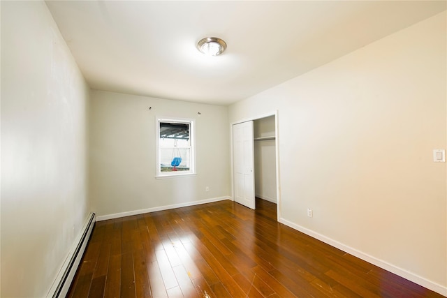 19623 56th Ave, Fresh Meadows, NY 11365 - unfurnished bedroom featuring a baseboard heating unit, dark wood-type flooring, and a closet