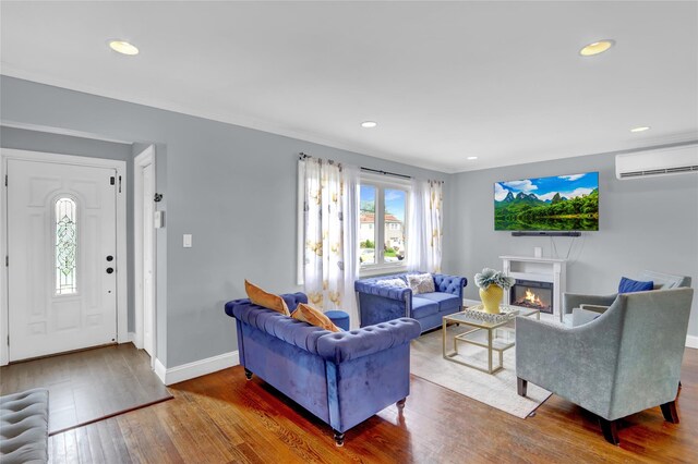 405 Miller Ave, Freeport, NY 11520 - living room featuring a wall mounted AC, wood finished floors, recessed lighting, baseboards, and a glass covered fireplace
