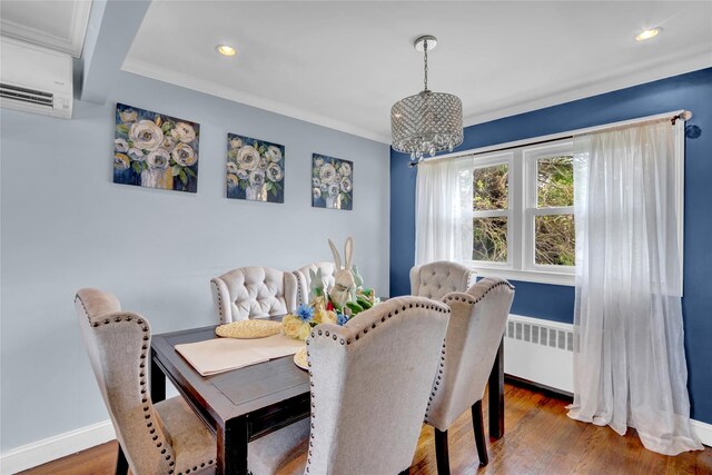 405 Miller Ave, Freeport, NY 11520 - dining space with an AC wall unit, a chandelier, radiator, recessed lighting, and wood finished floors