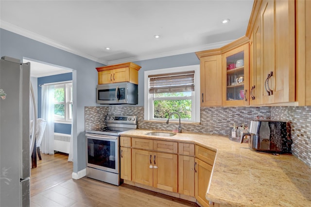 405 Miller Ave, Freeport, NY 11520 - kitchen featuring appliances with stainless steel finishes, radiator, a sink, light brown cabinetry, and ornamental molding