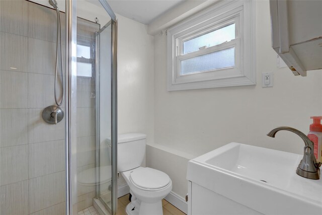 405 Miller Ave, Freeport, NY 11520 - full bathroom with a shower stall, toilet, vanity, and baseboards