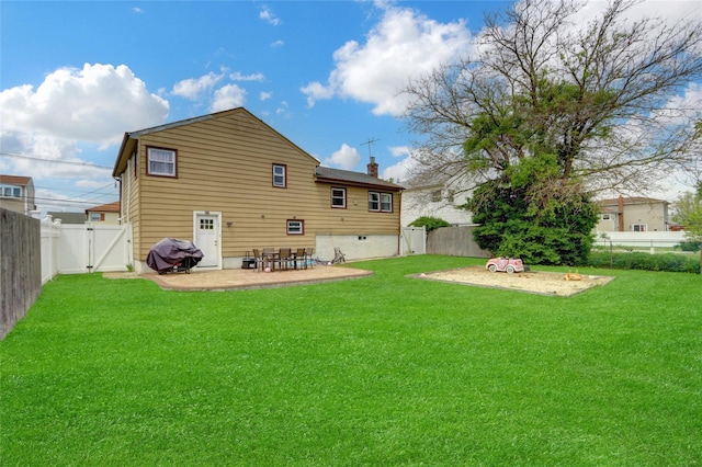 405 Miller Ave, Freeport, NY 11520 - back of house with a gate, a patio area, and a chimney