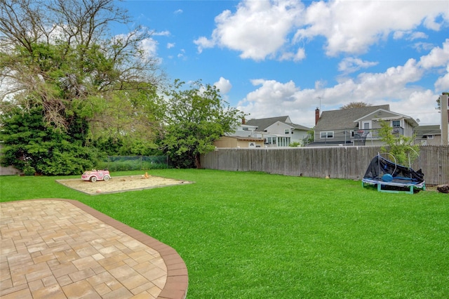 405 Miller Ave, Freeport, NY 11520 - view of yard featuring a trampoline and a patio area