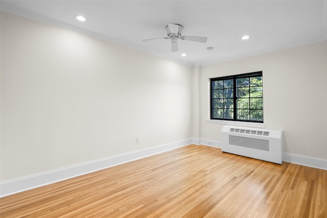 66 Milton Rd Unit C42, Rye, NY 10580 - empty room with radiator heating unit, light wood-style floors, baseboards, crown molding, and recessed lighting