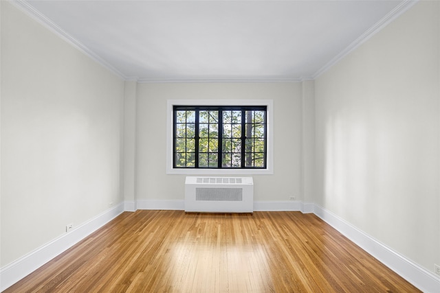66 Milton Rd Unit C42, Rye, NY 10580 - empty room featuring radiator heating unit, light wood-type flooring, baseboards, and crown molding