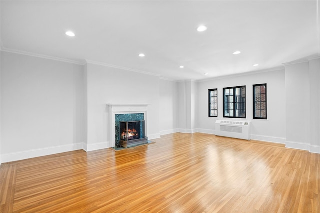 66 Milton Rd Unit C42, Rye, NY 10580 - unfurnished living room featuring light wood finished floors, recessed lighting, crown molding, baseboards, and a fireplace