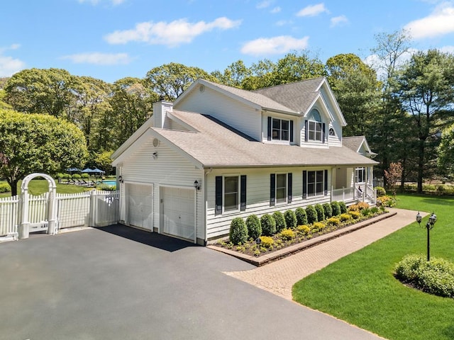 31 Inlet View Path, East Moriches, NY 11940 - view of front of property with asphalt driveway, a garage, roof with shingles, a chimney, and a gate