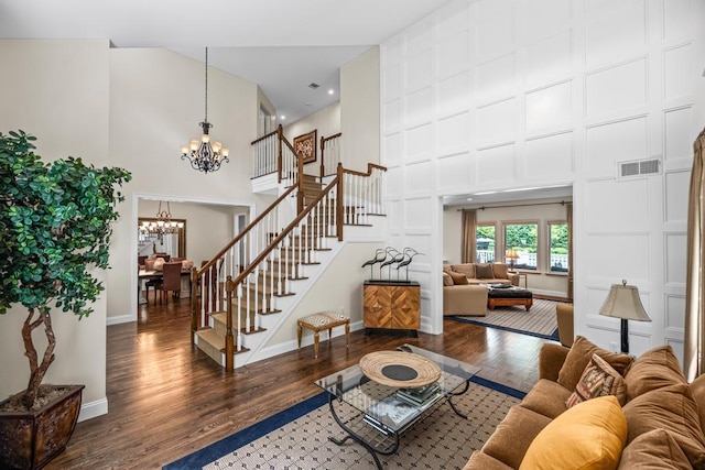 31 Inlet View Path, East Moriches, NY 11940 - living area with a high ceiling, a chandelier, wood finished floors, stairway, and baseboards
