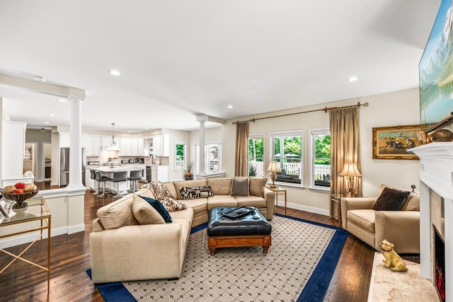 31 Inlet View Path, East Moriches, NY 11940 - living area featuring ornate columns, light wood-style flooring, a fireplace, recessed lighting, and baseboards