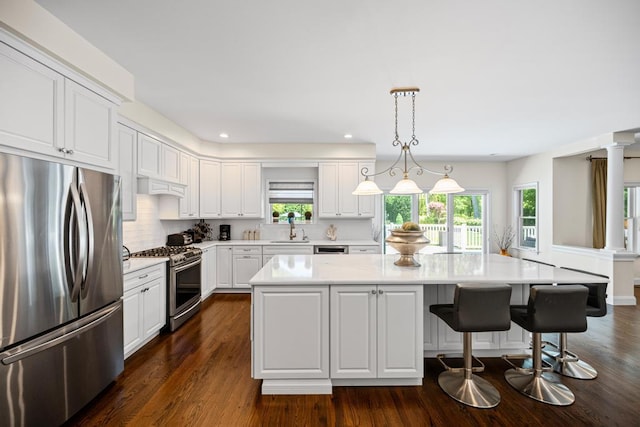 31 Inlet View Path, East Moriches, NY 11940 - kitchen featuring appliances with stainless steel finishes, a sink, light countertops, white cabinets, and dark wood-style flooring