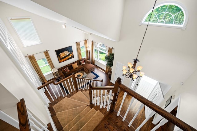 31 Inlet View Path, East Moriches, NY 11940 - staircase featuring a towering ceiling, healthy amount of natural light, wood finished floors, and a chandelier