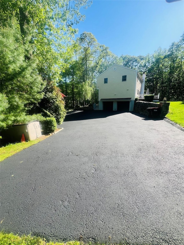 123 E St, South Salem, NY 10590 - view of home's exterior featuring an attached garage and asphalt driveway
