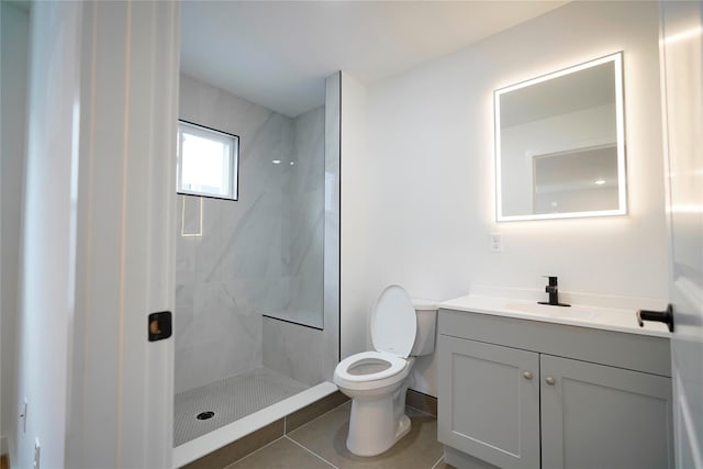 full bath with vanity, a shower stall, toilet, and tile patterned floors