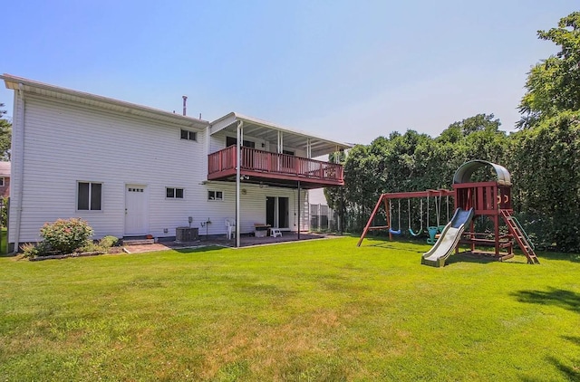 back of property featuring central AC, a yard, a playground, and a balcony