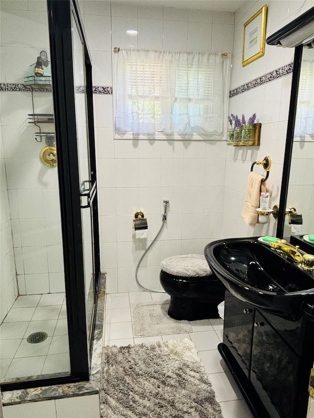 bathroom featuring tile walls, toilet, tile patterned flooring, a shower stall, and vanity