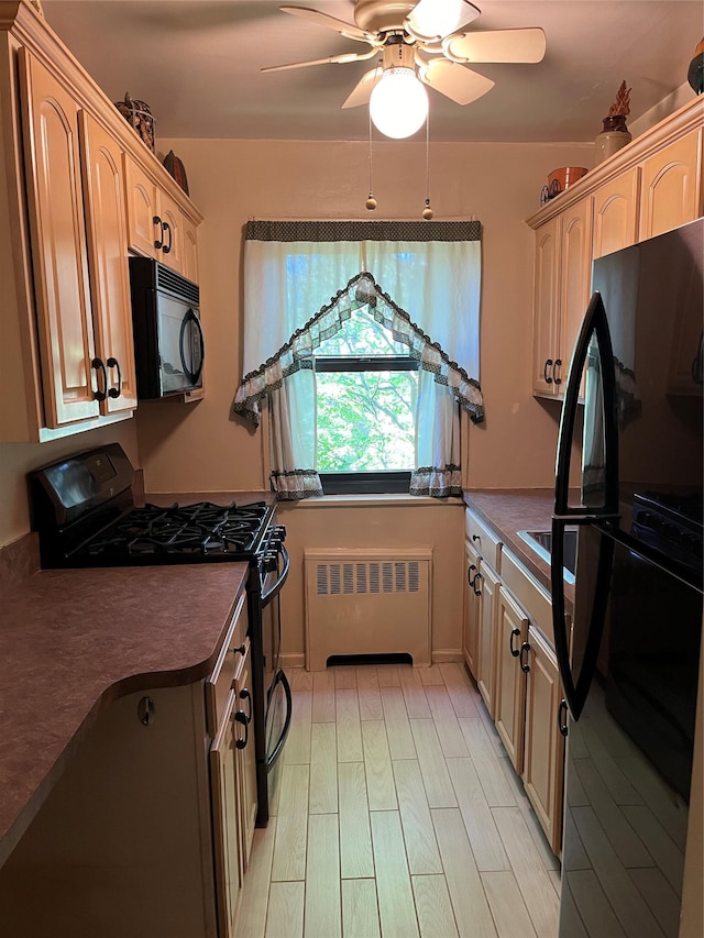 19933 22nd Avenue -, Whitestone, NY 11357 - kitchen featuring black appliances, radiator heating unit, dark countertops, a ceiling fan, and light wood-type flooring