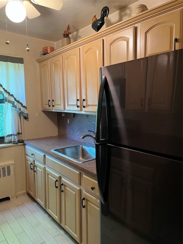 19933 22nd Avenue -, Whitestone, NY 11357 - kitchen featuring freestanding refrigerator, a sink, radiator heating unit, backsplash, and dark countertops