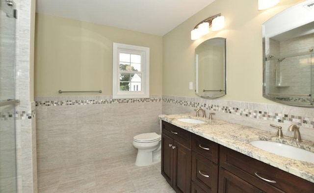 110B Louis St, Massapequa, NY 11758 - full bathroom with tile walls, a shower stall, toilet, wainscoting, and double vanity