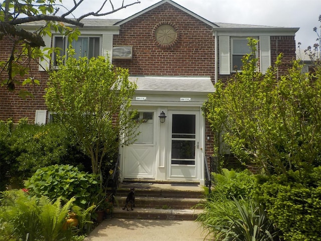 264-17 Langston Ave Unit E-2, Glen Oaks, NY 11004 - property entrance featuring brick siding and a shingled roof