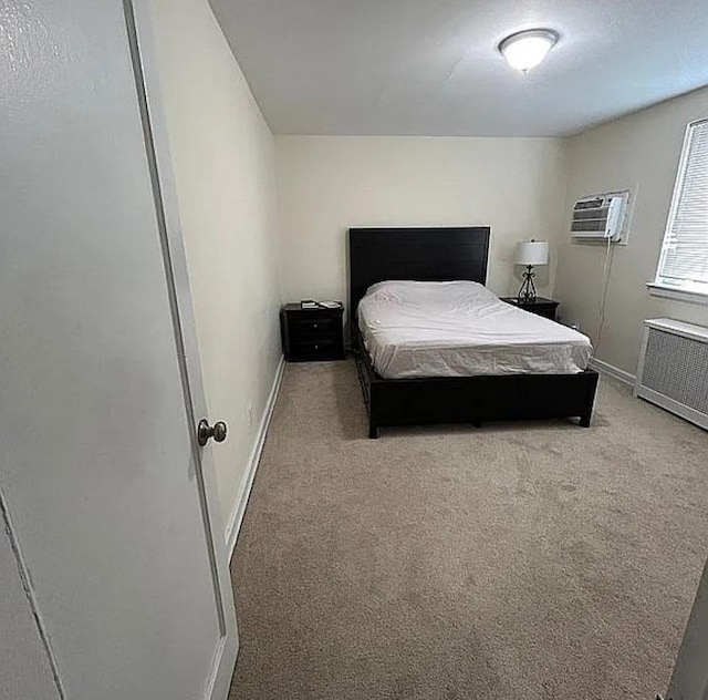 264-17 Langston Ave Unit E-2, Glen Oaks, NY 11004 - carpeted bedroom featuring radiator, baseboards, and an AC wall unit