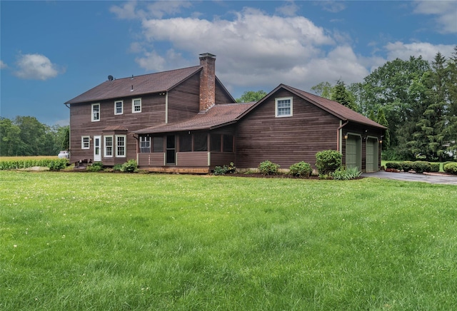 162 Lippincott Rd, Wallkill, NY 12589 - view of front of house featuring a chimney, asphalt driveway, a front yard, and a sunroom